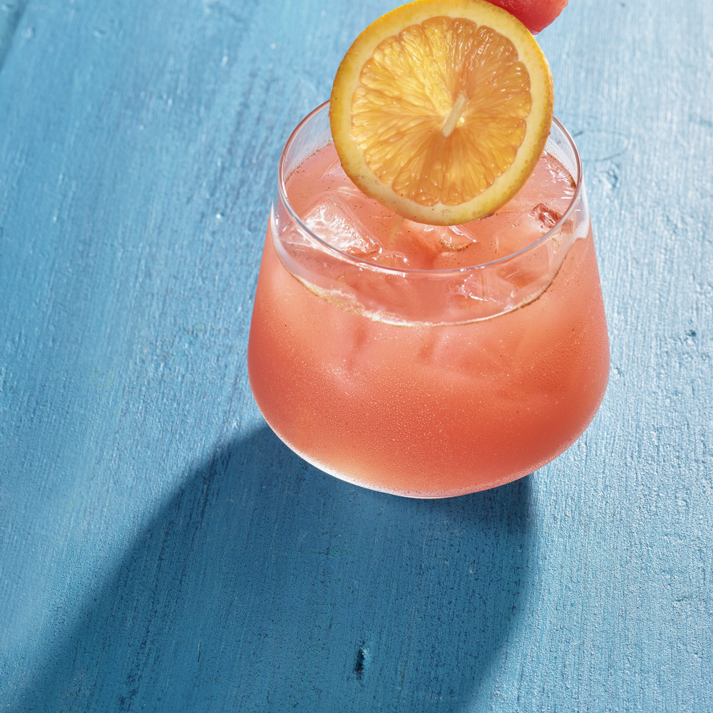 watermelon cocktail with ice, orange slice and watermelon ball