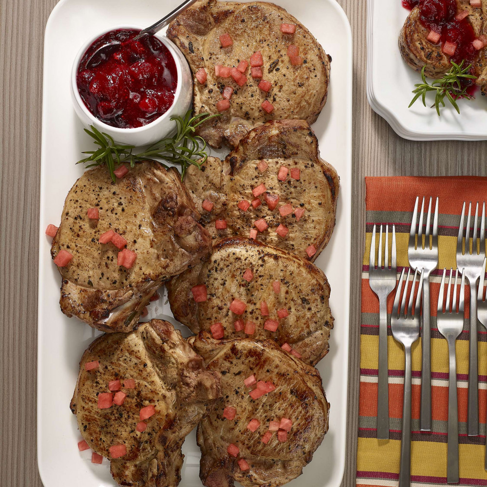 Pork chops with watermelon and cranberry glaze on a serving platter.