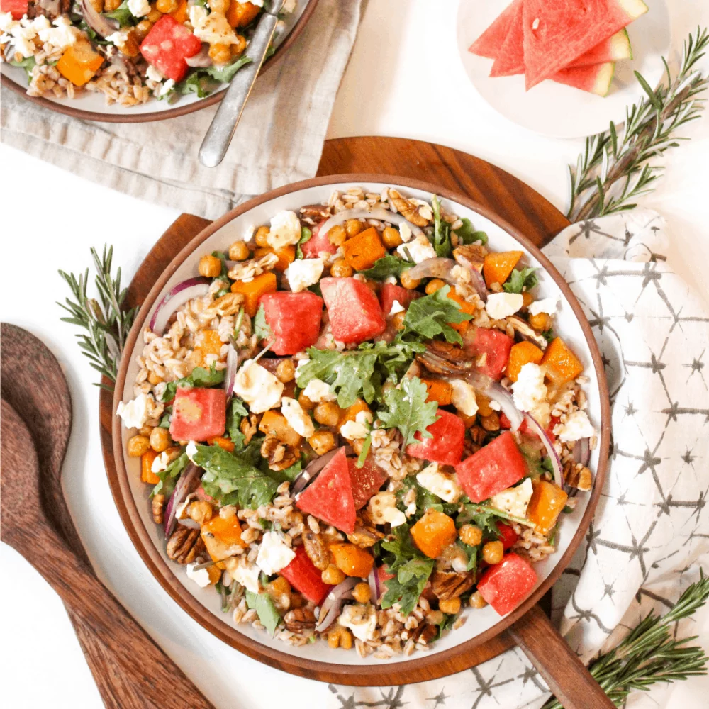 Salad in a bowl with watermelon, farro, feta and arugula