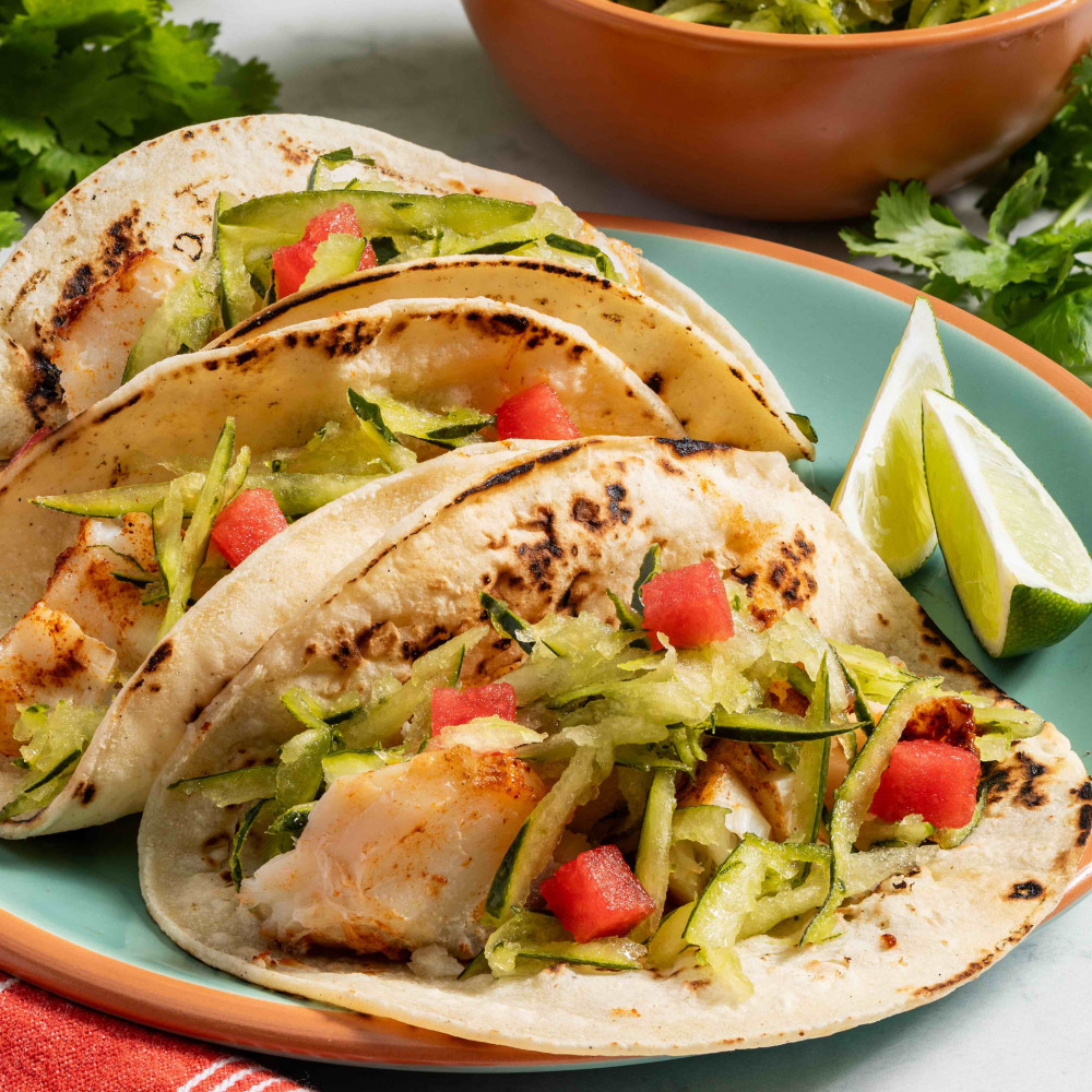 Plated fish tacos with watermelon rind coleslaw on top