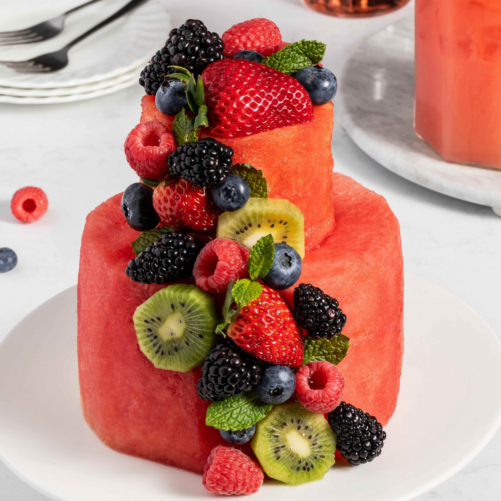 "Cake" made of watermelon and other fruit such as kiwi and berries set on a plate