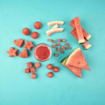 watermelon cuts and shapes including wedges, sticks, dices, cubes, balls, cut out hearts and stars and watermelon rind on a blue background