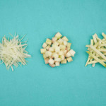 three piles of watermelon rind - shaed, cubes and sticks on blue background