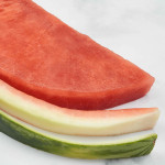 watermelon flesh, rind and green skin in half circle and cut